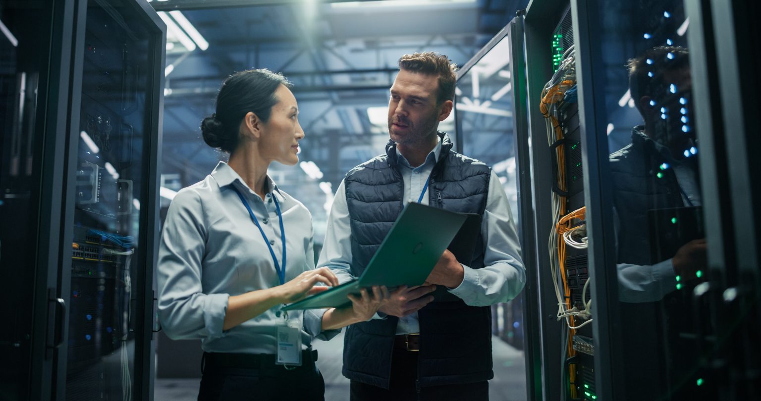 Zwei IT-Spezialisten prüfen Systeme im Rechenzentrum